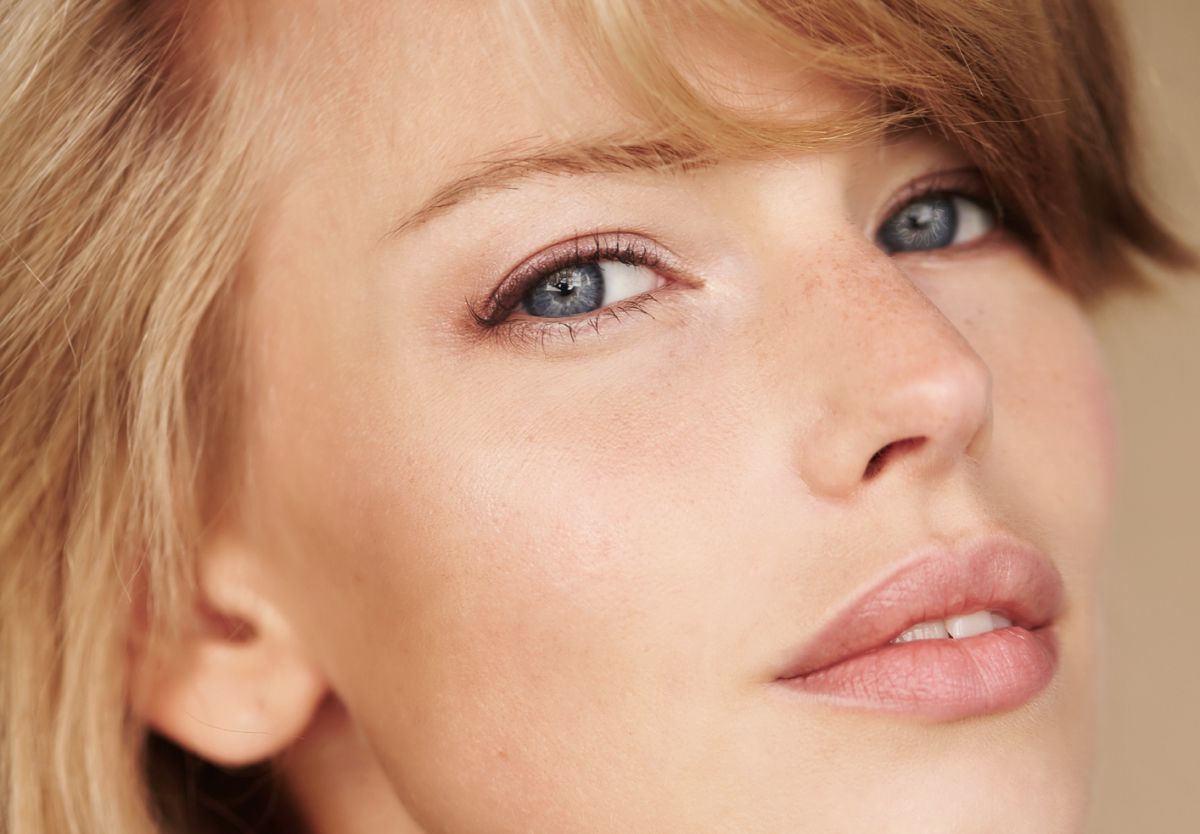 Close-up of a woman's face with blue eyes.